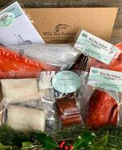 Load image into Gallery viewer, A seafood gift box from Wild Bay Seafood Company, containing packaged salmon and black cod portions, with ice packs and branding visible.

